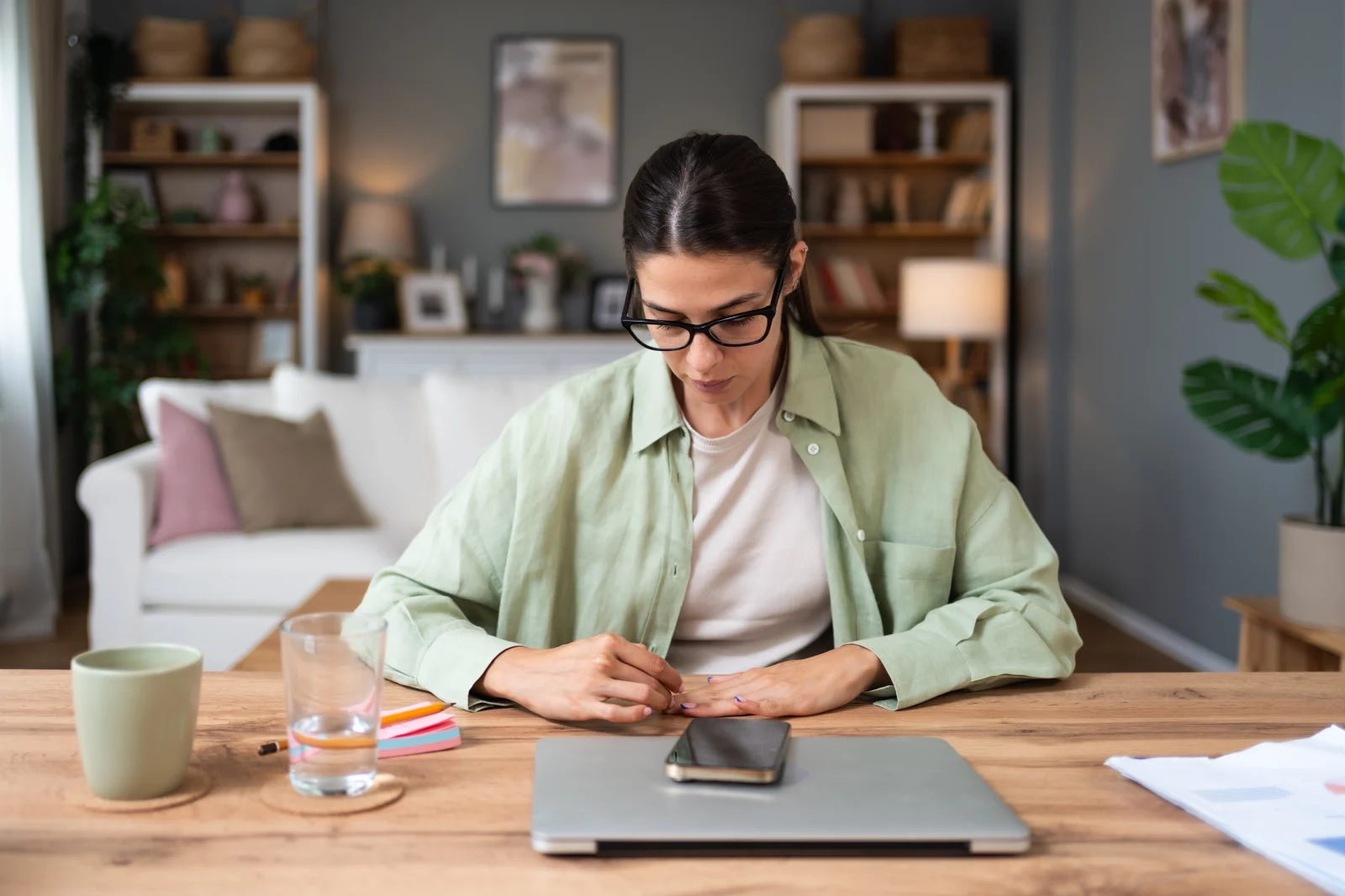 Woman sitting at a table with her laptop – online psychiatry in Anaheim, CA